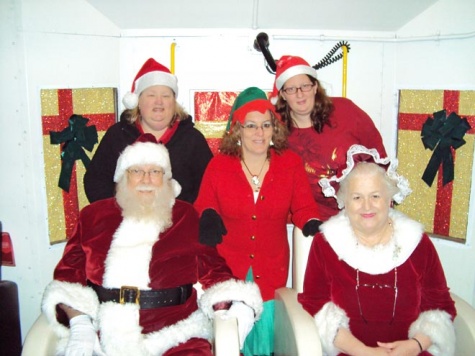 Santa and Mrs. Claus with elfs Penny, Cinthia, Angel.